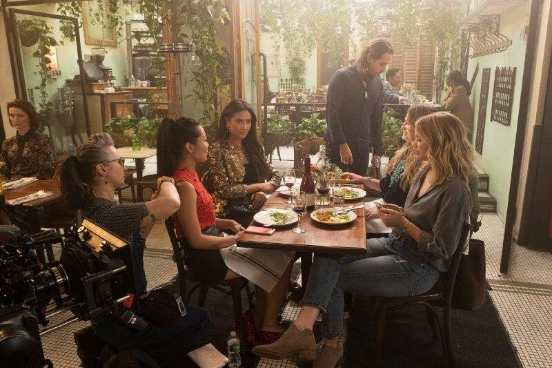 The team collaborating on the set of “YOU.”