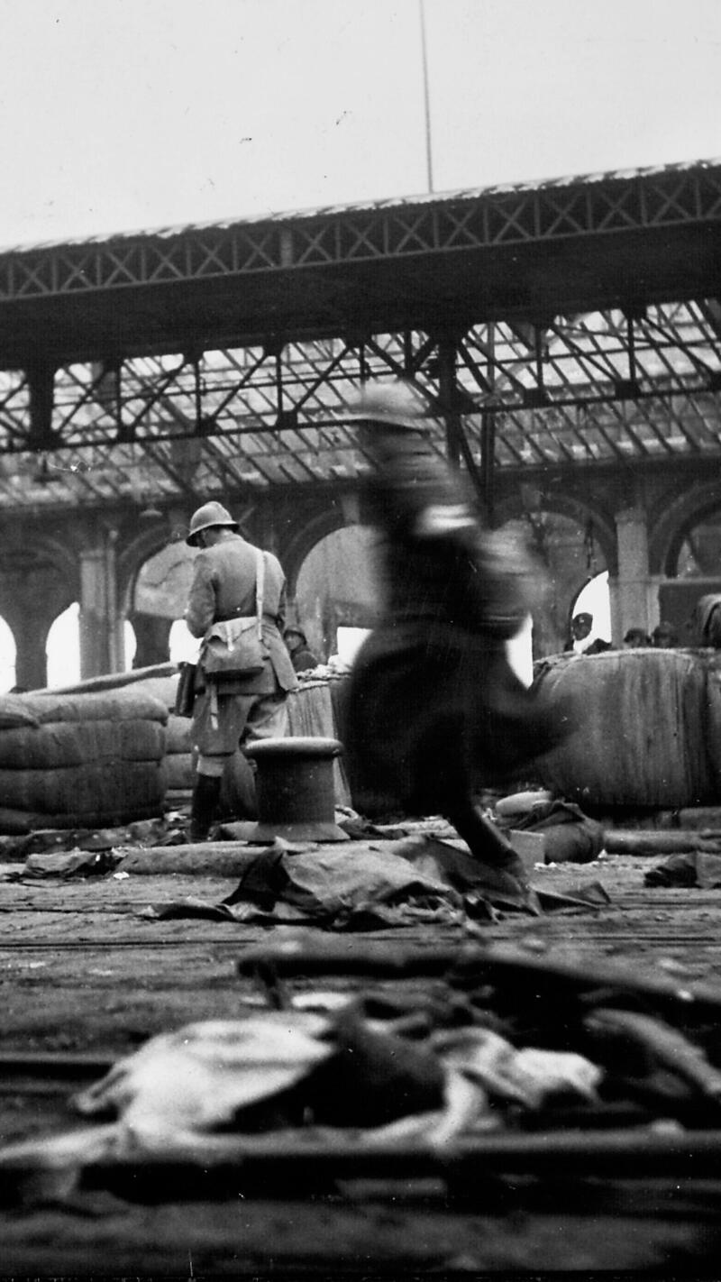 Bomb-damaged docks patrolled by French Troops