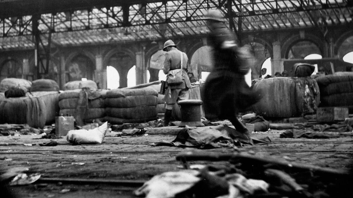 Bomb-damaged docks patrolled by French Troops