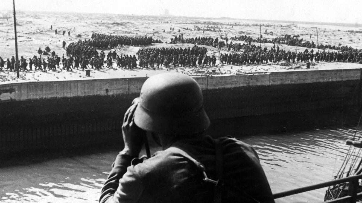 A German soldier looking out at Allied Forces trying to evacuate