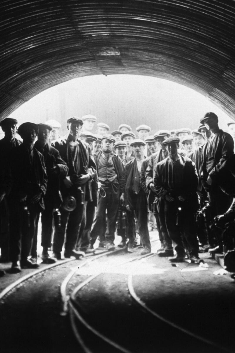 Coal miners standing at the head of Tilmanstone Colliery, Kent, England