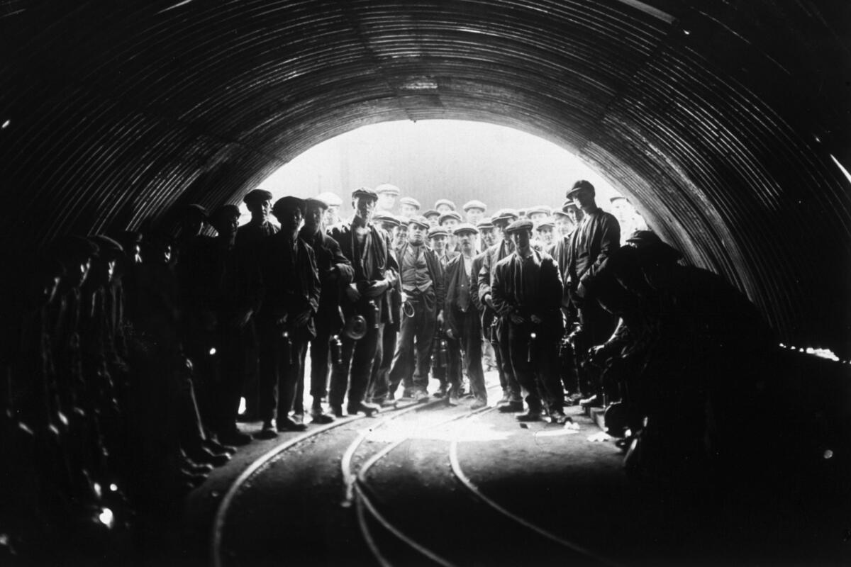 Coal miners standing at the head of Tilmanstone Colliery, Kent, England
