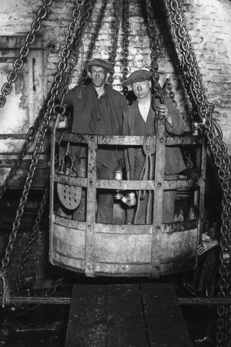 Coal miners in mine cage.