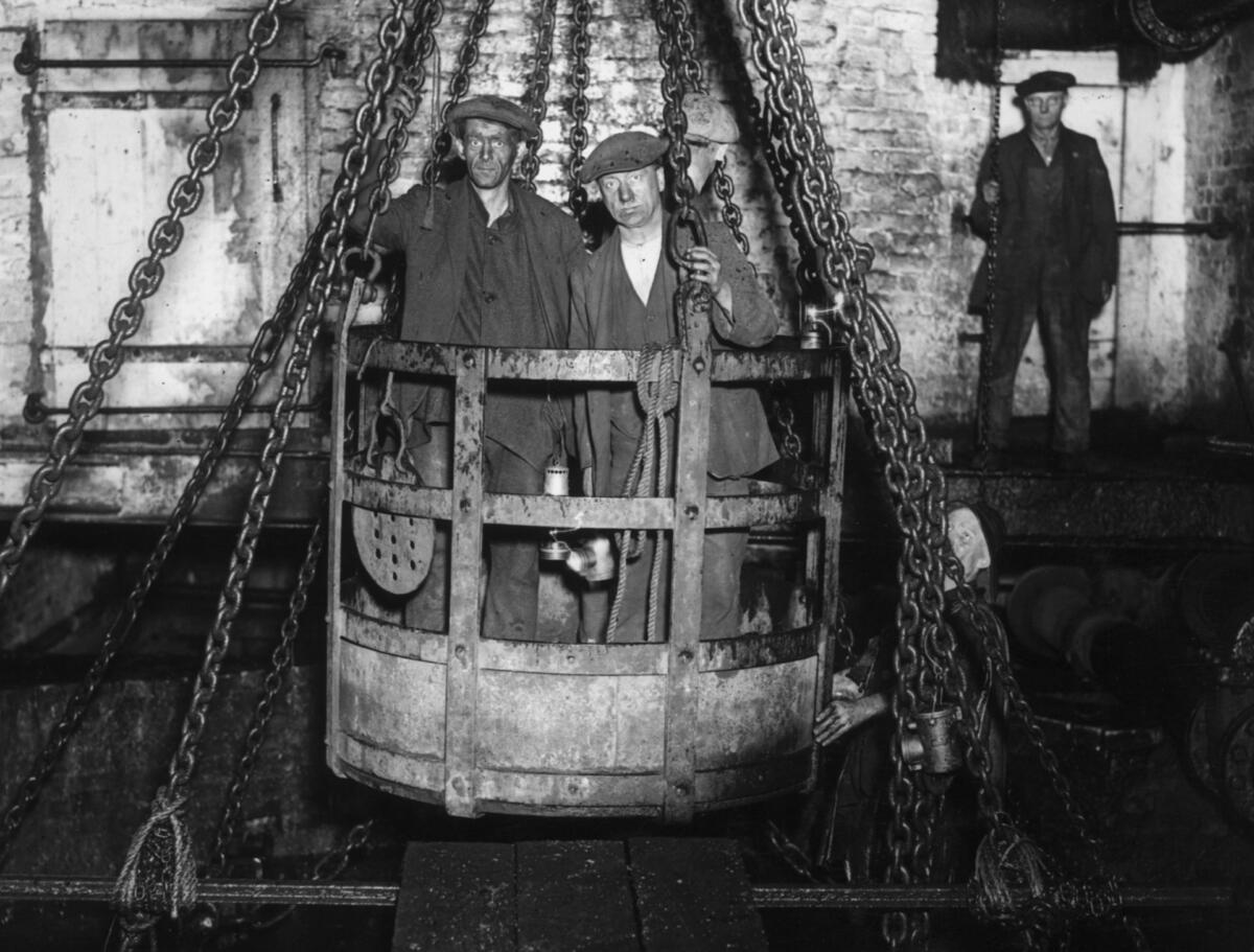 Coal miners in mine cage.