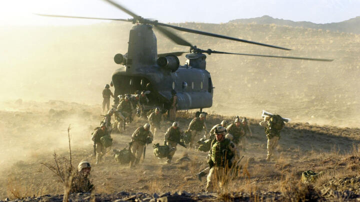 U.S. Army soldiers from the 101st Airborne division off load during a combat mission from a Chinook 47 helicopter March 5, 2002 in Eastern Afghanistan.