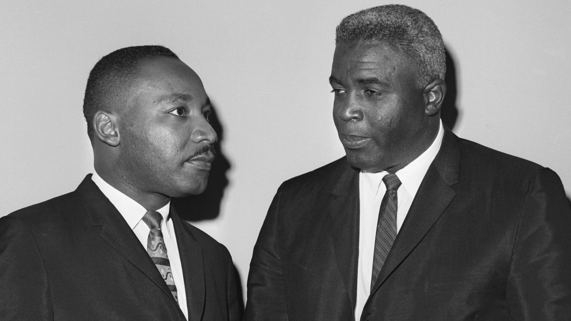 Martin Luther King Jr and Jackie Robinson at a 1962 press conference. (Credit: Bettmann/Getty Images)