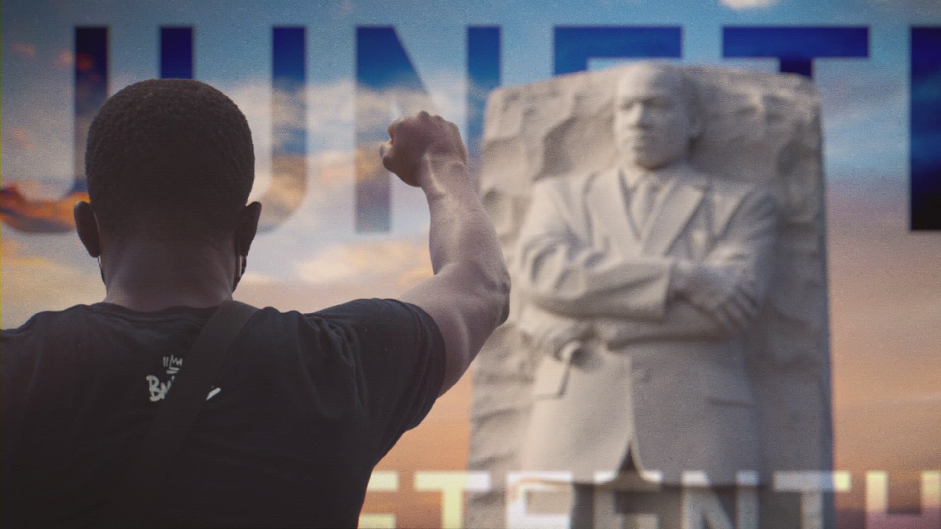 a photo of a child saluting the martin luther king jr statue