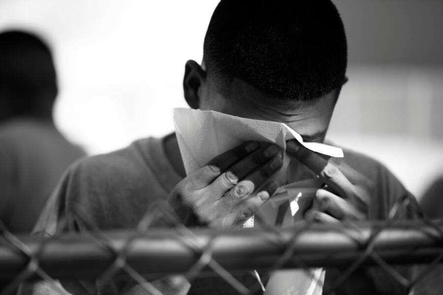 A cadet wipes his face