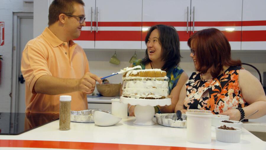 Sean, Elena, and Rachel decorate a cake