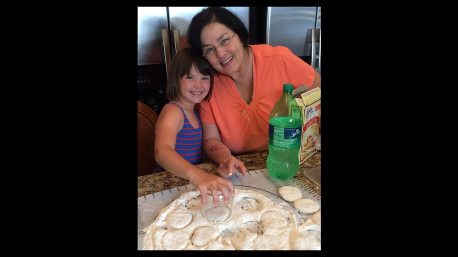 Priscilla Robertson helping grandma Kay Robertson in the kitchen