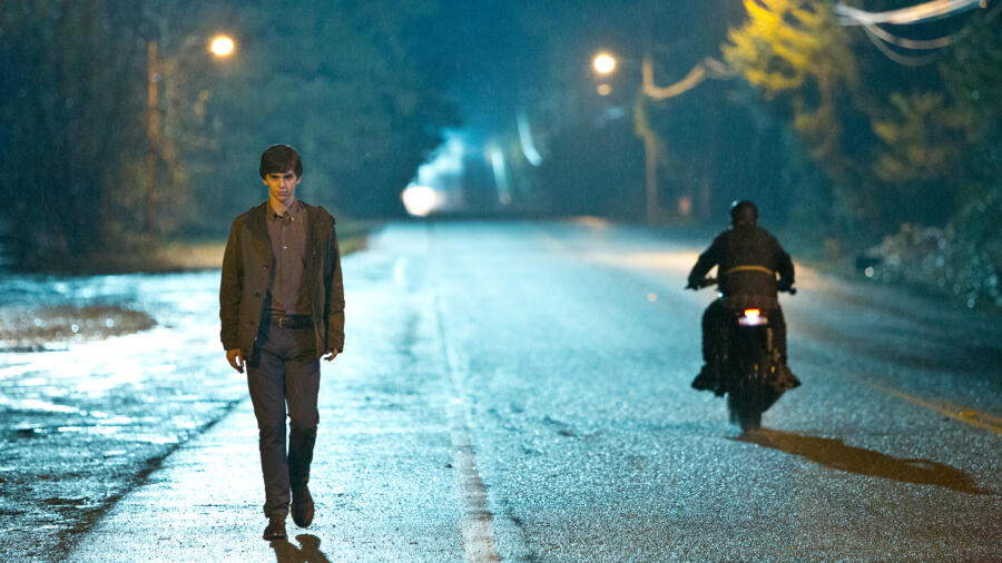 Dylan follows Norman by motorcycle