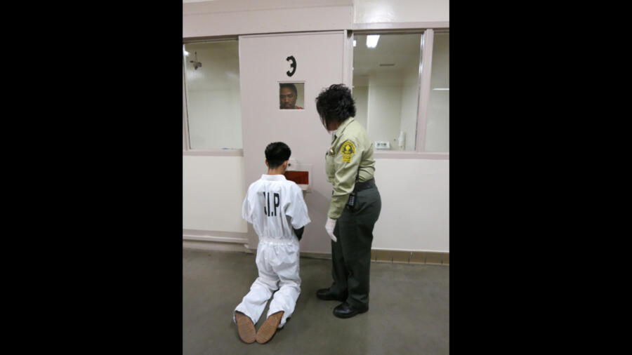 Teen forced to knees by inmate