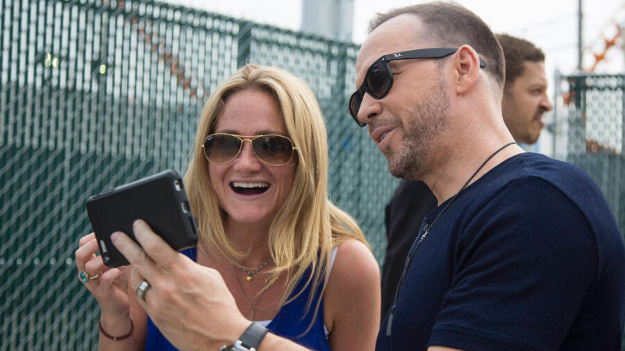 Kari checks out Donnie's phone.