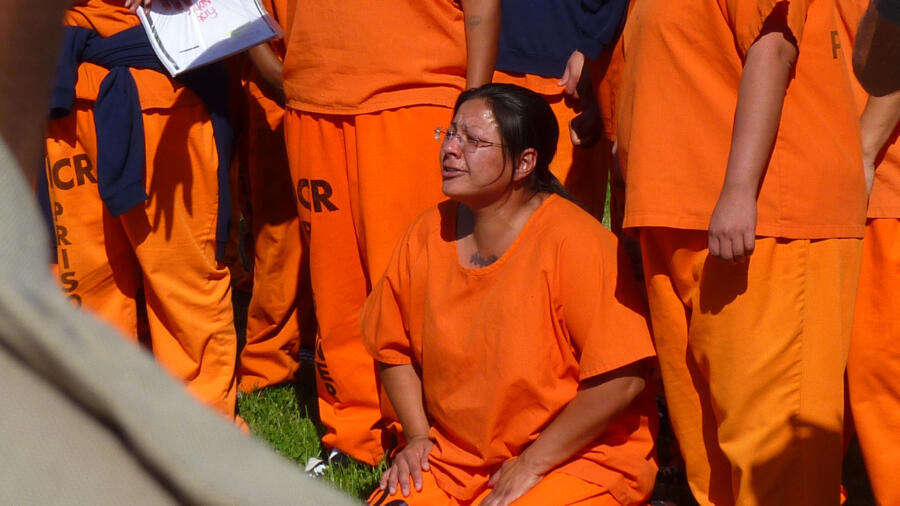 An incarcerated mother is surprised to see her daughter