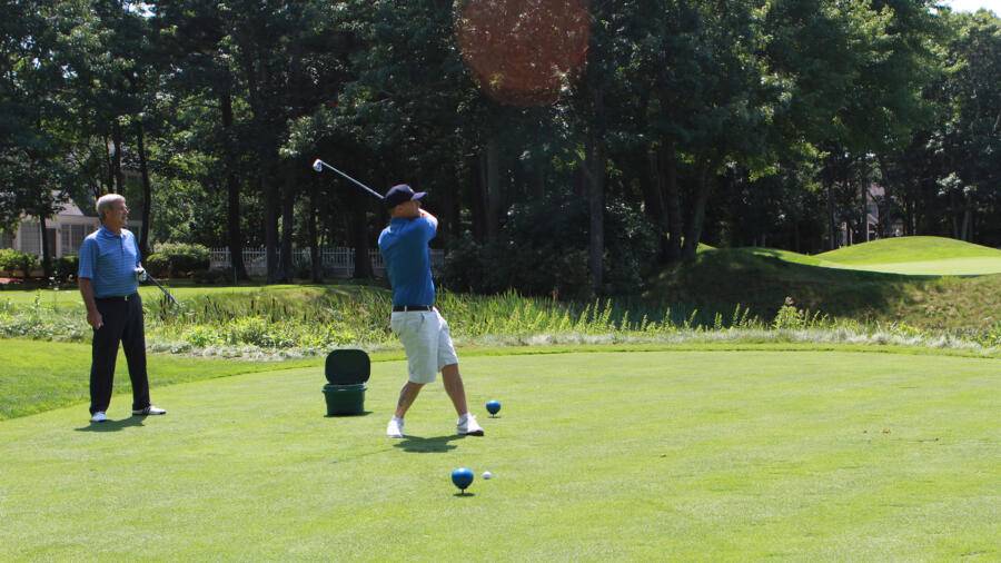 Jim takes a swing while Bobby Orr looks on