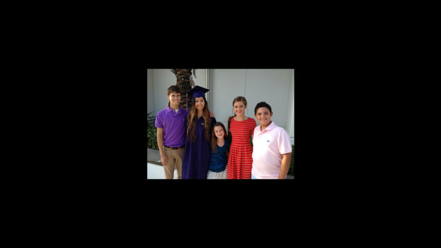 Rebecca at her college graduation with her American siblings