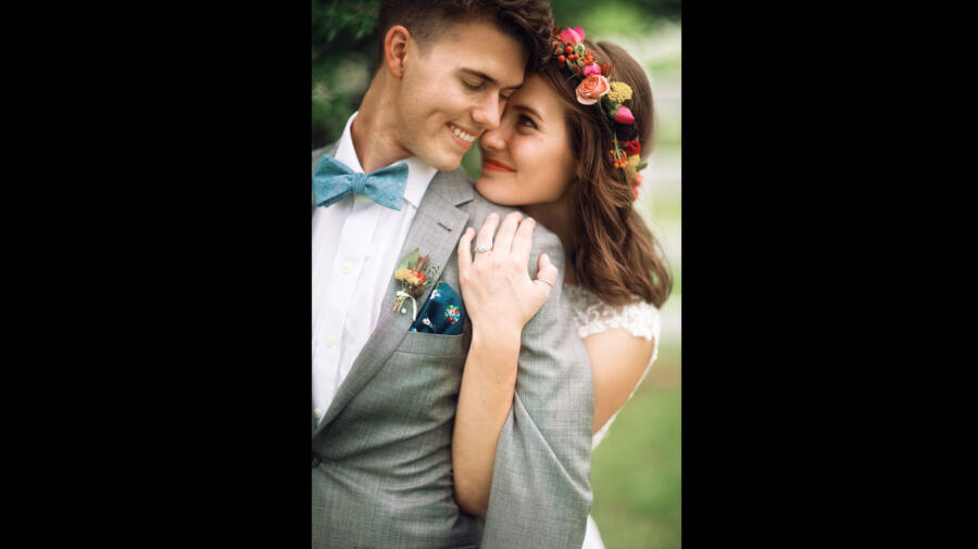John Luke and Mary Kate pose for a photo on their wedding day