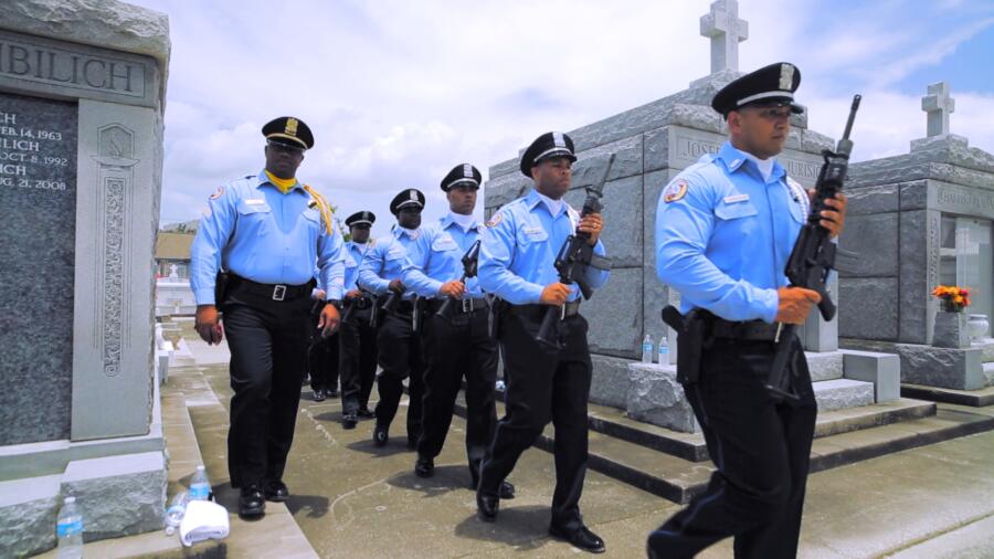 Officers get ready for a gun salute during Officer Holloway's funeral