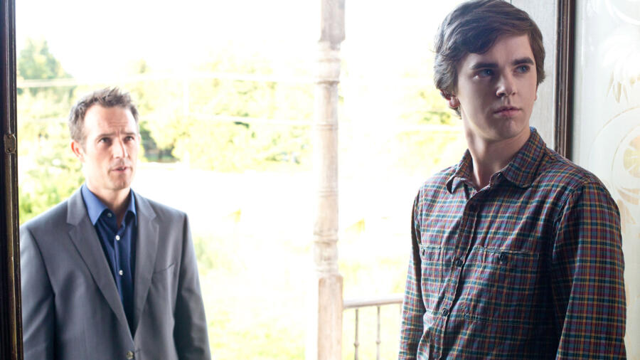 Norman opens the door for George.