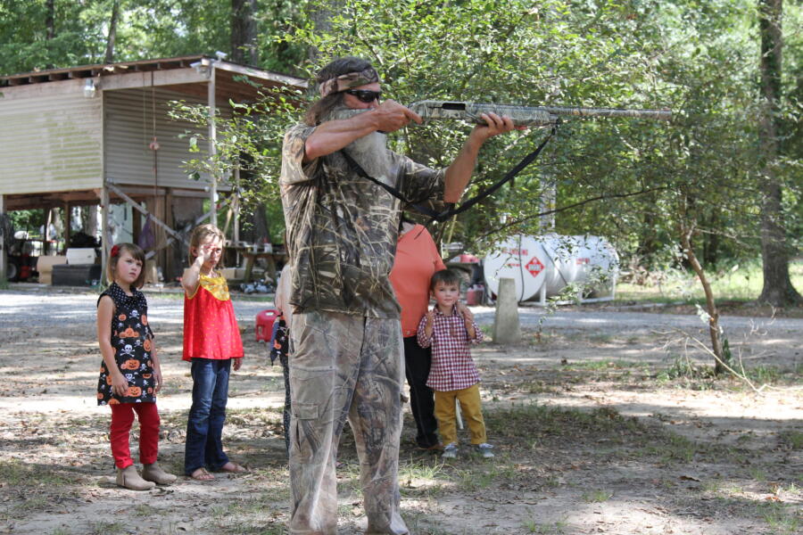 After the kids say the jack-o-lantern isn't scary enough, Phil uses his gun to blast a beard onto it.