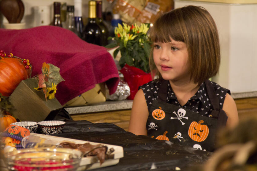 Jep and Jessica's daughter Priscilla hangs out in the kitchen as her grandma Kay creates Halloween treats.