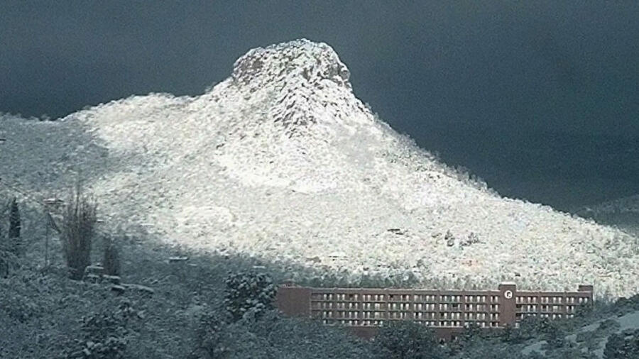 Thumb Butte in Prescott, Ariz., shines in the morning sun after a spring snowstorm Thursday, April 2, 1998. AP Photo/The Daily Courier, Tom Hood