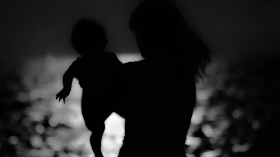 Silhouette Woman Carrying Baby At Beach During Night