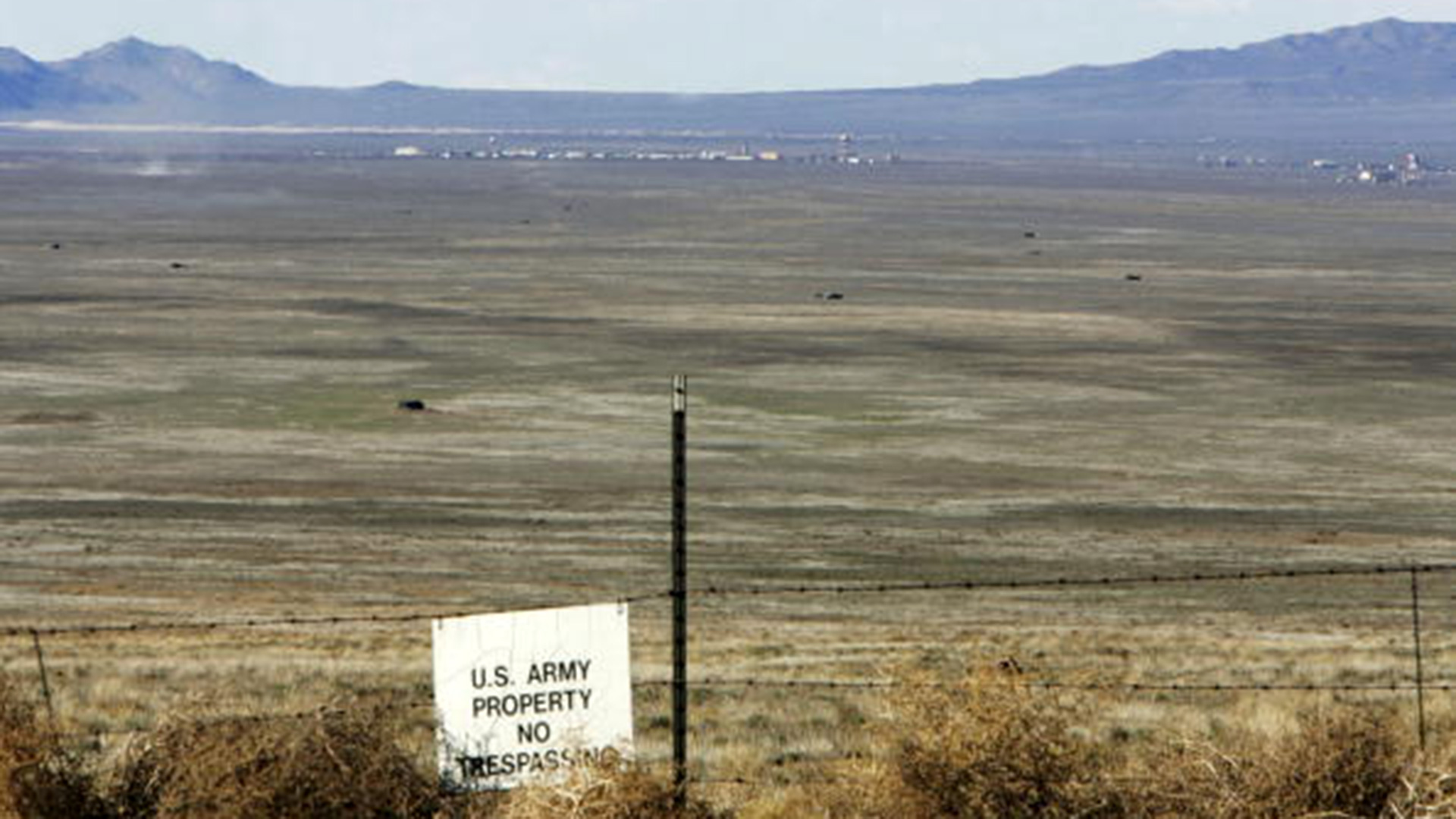 A warning sign marks the boundary of Dugway Proving Ground in the middle of Rush Valley.