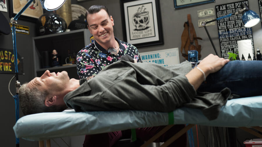 Robbie, who is also a Houston firefighter, prepares to work on Sticks' tattoo.