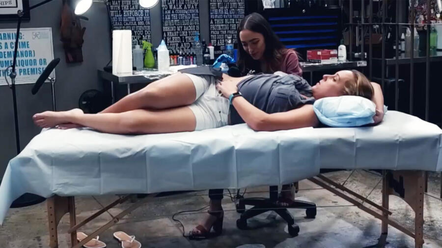 Janice Danger works on an orchid tattoo for Holly Horton, a police sergeant out of Texas.