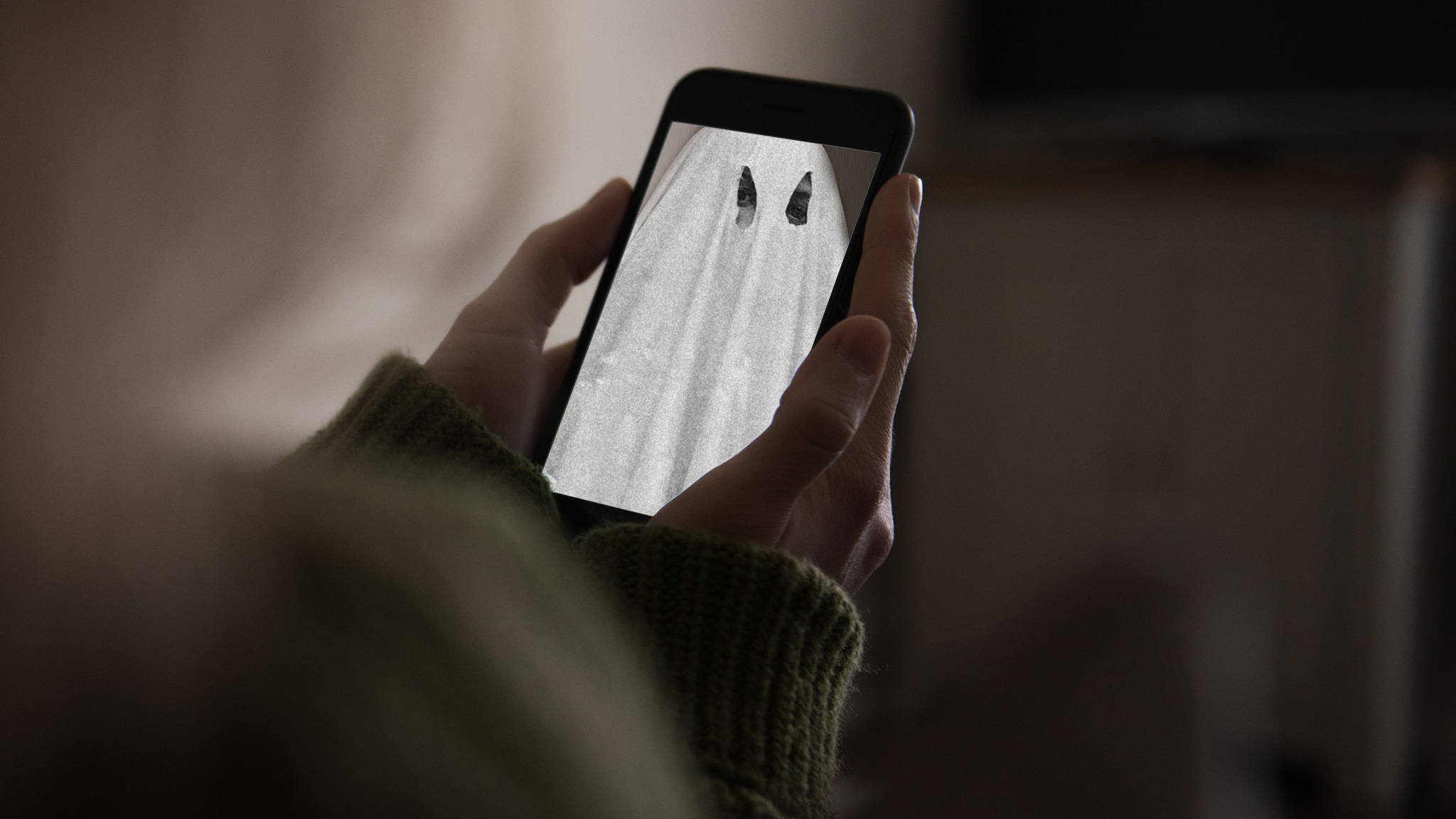 A lady sees a ghost on her smartphone