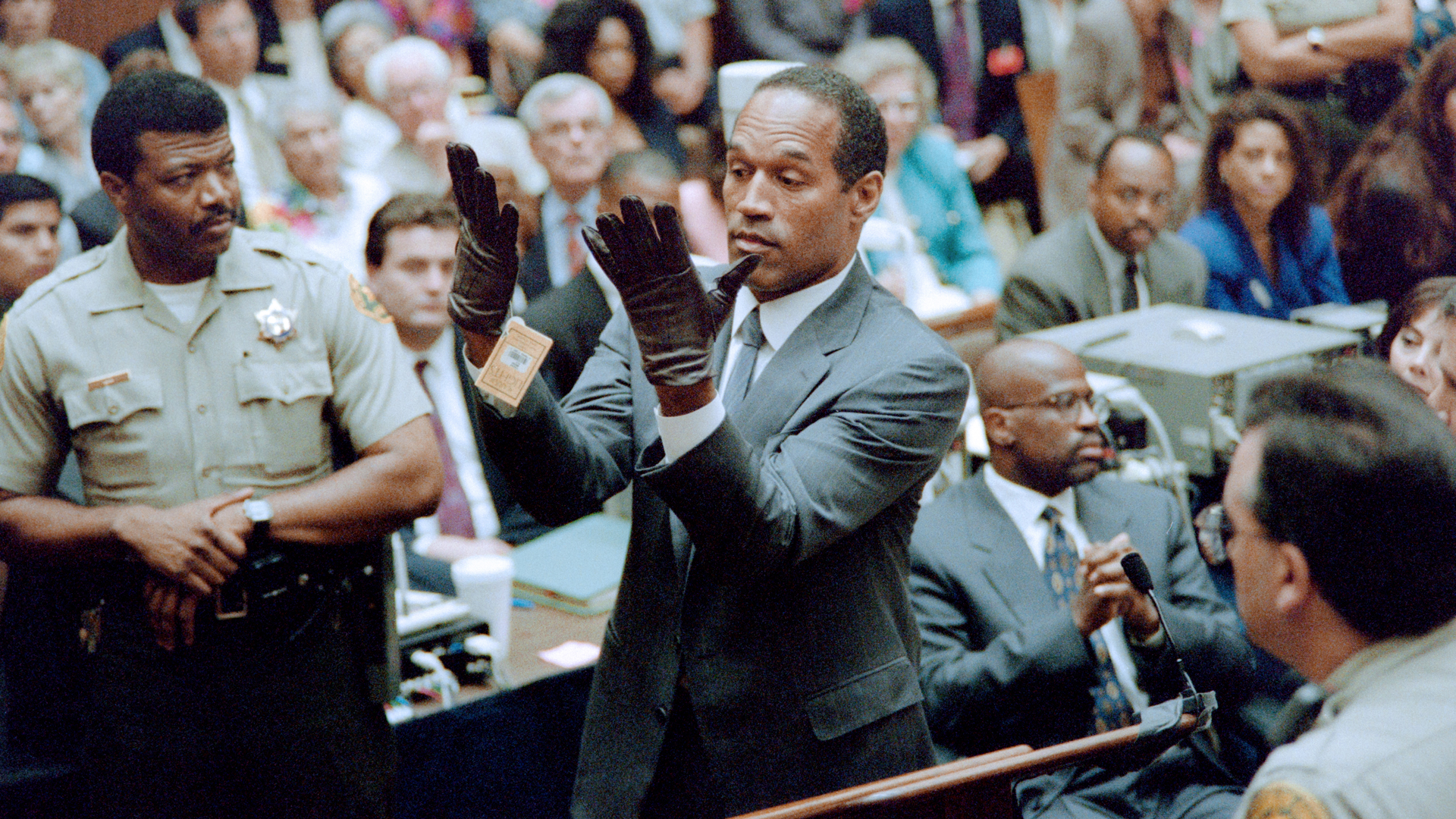 O.J. Simpson tries on gloves in court