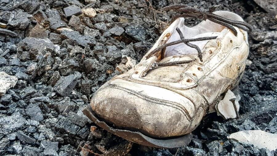 Shoe amid the remains of a home destroyed by a fire