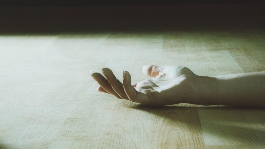 Woman's hand on the floor
