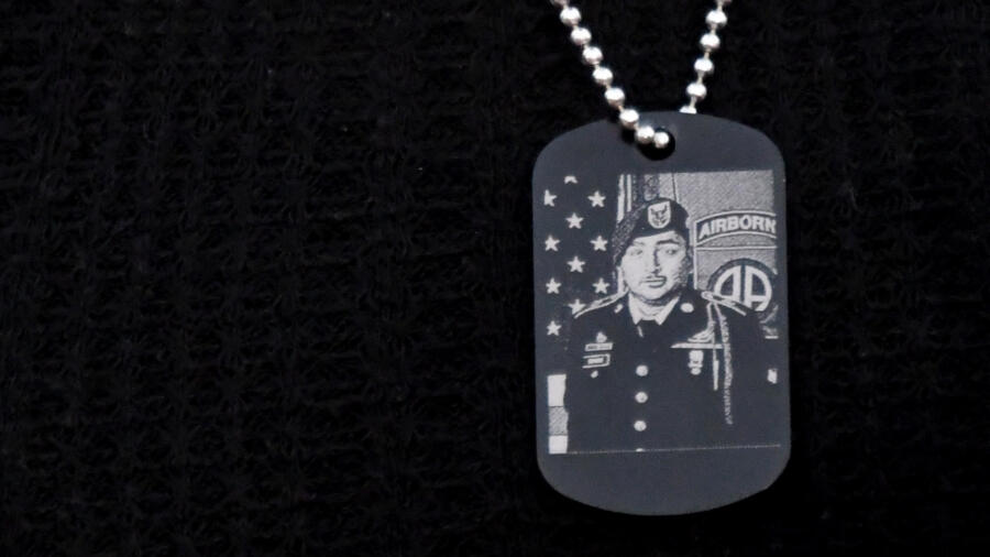 Dog tag with photo of Army Specialist Enrique Roman-Martinez