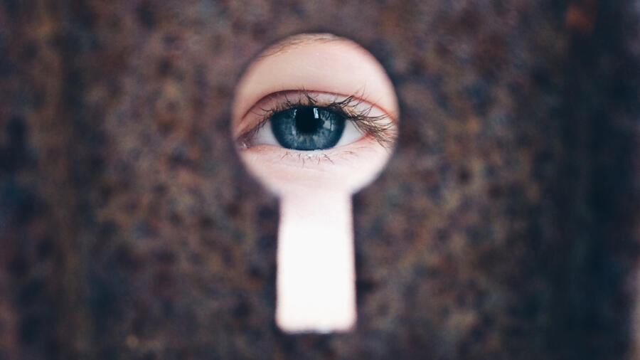 A girl looking through a keyhole