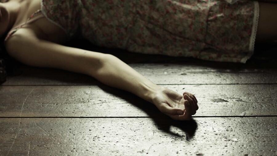 Conceptual photo of a murdered woman on the floor