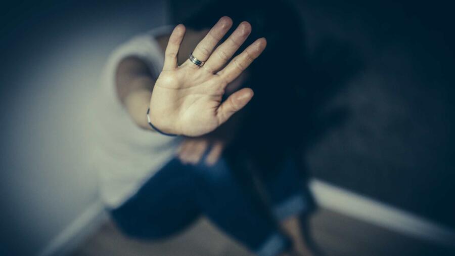 A conceptual photo of an abused woman trying to defend herself