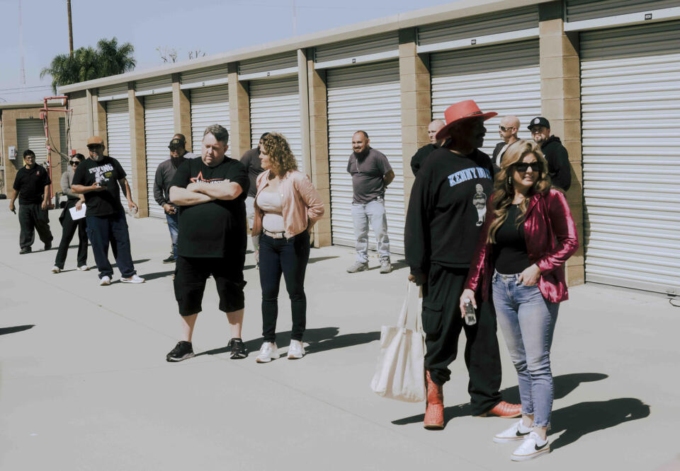 Brandi Passante and other hopeful bidders wait for an auction to begin.