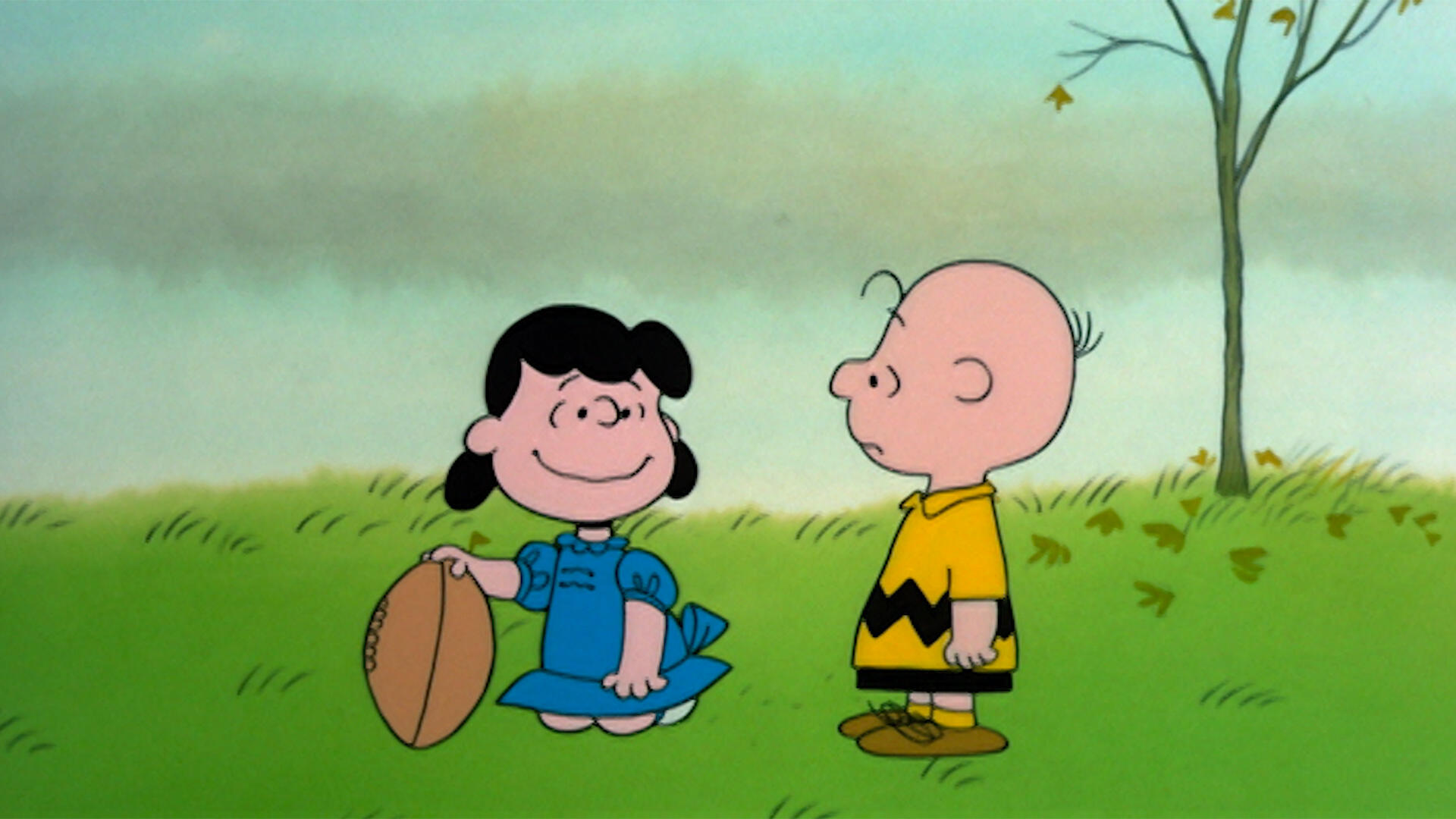 Lucy holding the football for Charlie Brown