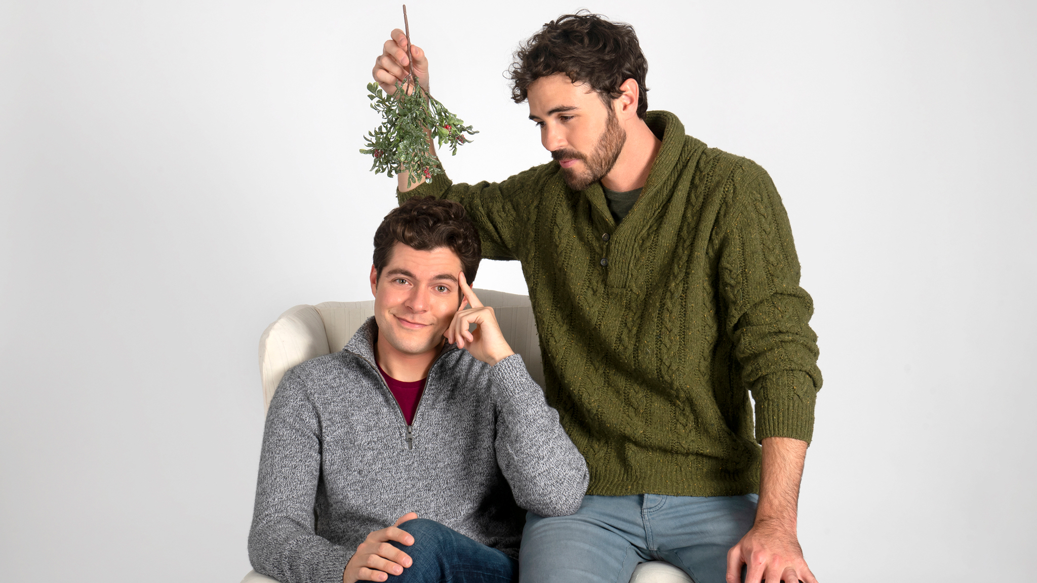 Ben Lewis and Blake Lee from Lifetime's 'The Christmas Setup' pose with mistletoe