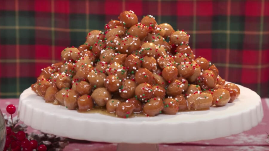 A festive pile of glazed and sprinkled cake balls presented on a plate.